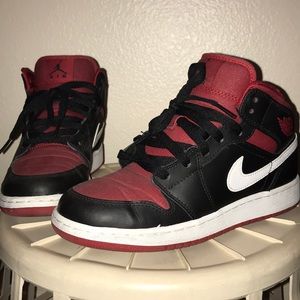 Black with red and white accent Air Jordan 1 Mids.